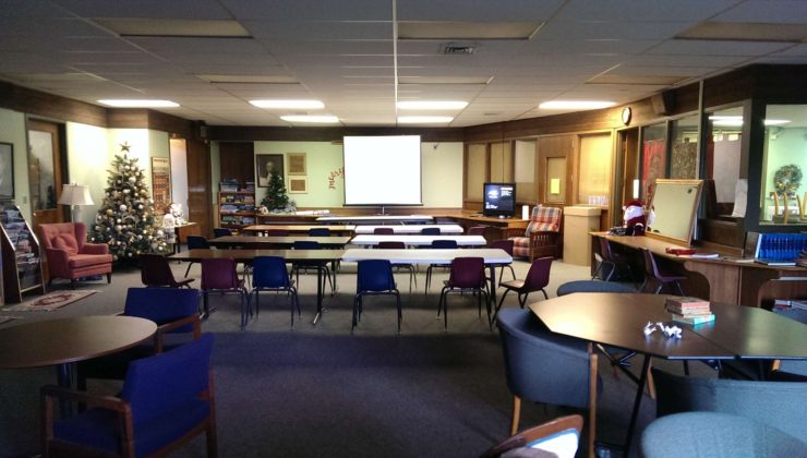 Picture of the library space setup for a class with projection screen
